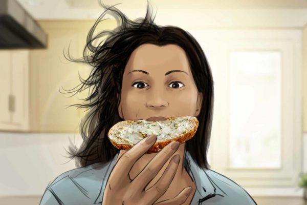 A woman eating a bagel with cream cheese.